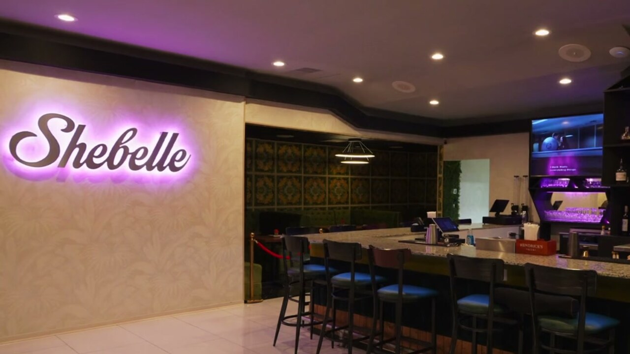 Shebelle lounge, bar seating, and illuminated wall logo